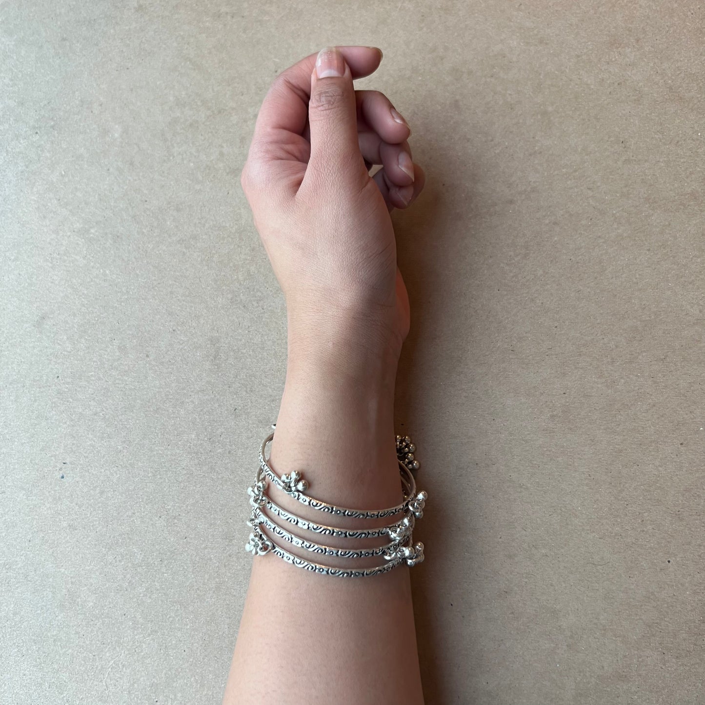 silver bangles with mini bells